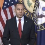 Hakeem Jeffries speaking at a podium on Capitol Hill