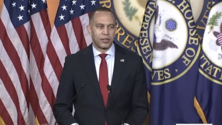 Hakeem Jeffries speaking at a podium on Capitol Hill