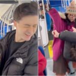 Bus interior with seated passengers and a window showing city street