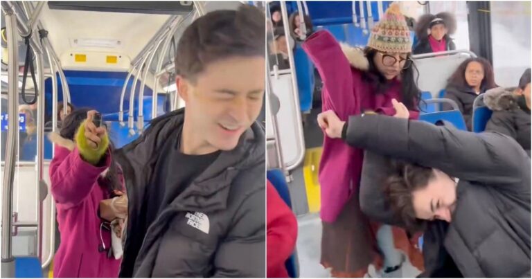 Bus interior with seated passengers and a window showing city street