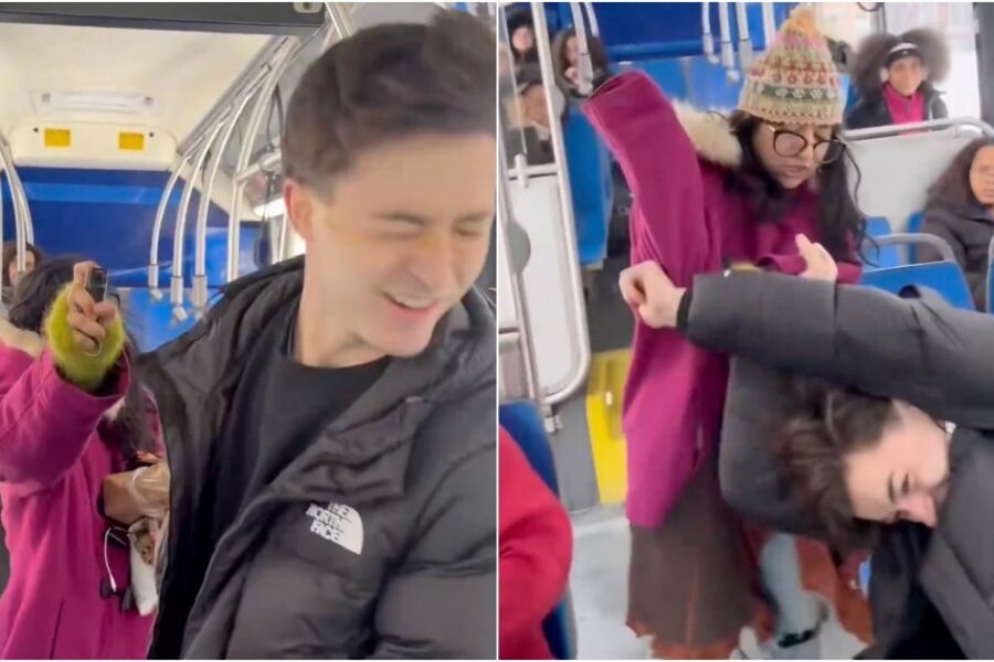 Bus interior with seated passengers and a window showing city street